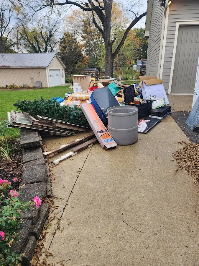 Dumpster being loaded with debris for 12 Yard Dumpster Rental in Dunbar